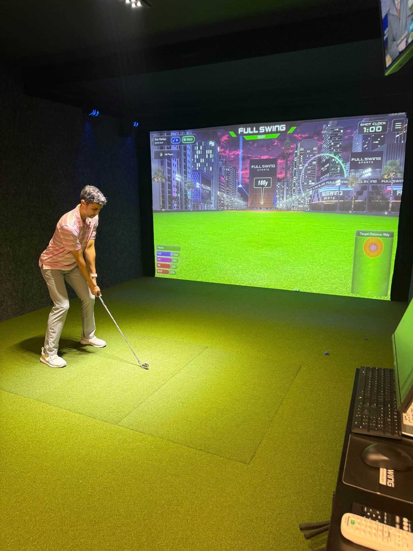 Golfer hitting a shot in the Swing 365 Beatrice simulator bay